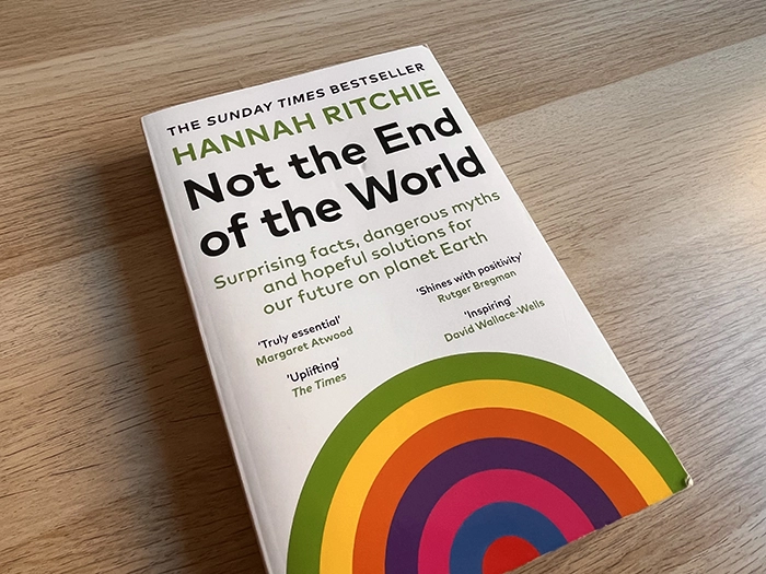 A physical copy of "Not the end of the world" on a wooden table.